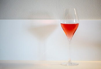 One glass of rose wine on white background
