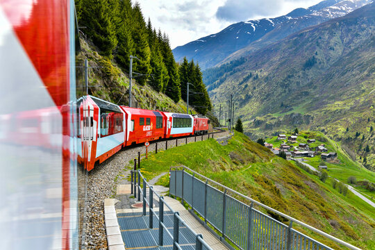 Zermatt 24,5,2023: Glacier Express red swiss train in Swiss Alps.Zermatt to St. Moritz. Switzerland in summer