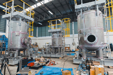 Stainless vertical steel tanks and pipes with pressure meter in equipment tank