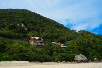 Fototapeta na wymiar Houses overlooking the sea on the mountain facing the beach in Brazil