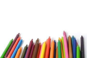 Crayons lined up isolated on white background.