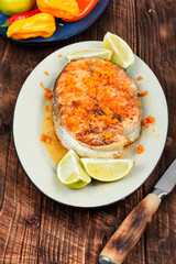 Salmon or trout steak in orange marinade.