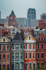 Fototapeta premium A panoramic view of a large group of buildings with a city in the background. This image captures the bustling urban landscape and the vibrant cityscape.