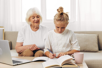 Bonding selfie education togetherness family grandmother granddaughter laptop hugging smiling sofa child