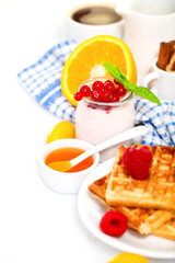 Delicious breakfast with fresh coffee, fresh waffles and fruits