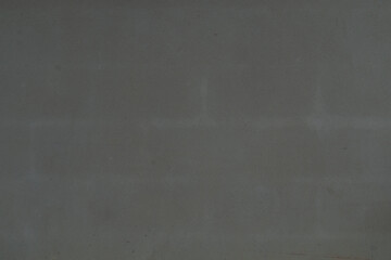 Background and textured of floor of the newly plastered wall was so damp that bricks could be seen. Wall for building of new house.