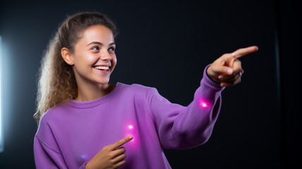 Happy woman points to the side black background purple colors neon