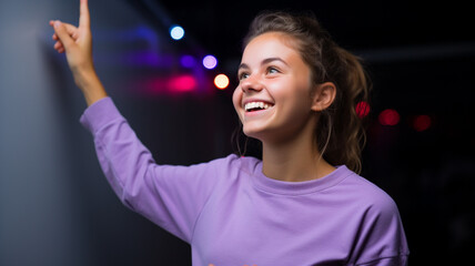 Happy woman points to the side black background purple colors neon