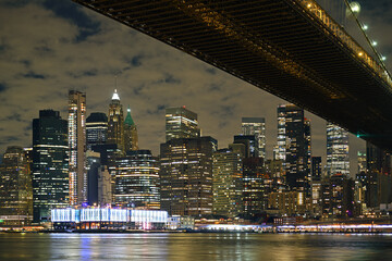 View of Manhattan and Brooklyn Bridge at night in winter. New York City, United States