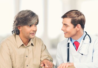 A professional doctor man sharing information to patient.