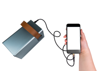A smartphone with a blank transparent screen in hand is charged from a large power supply (charging station) via a USB cable on a transparent background. Mobile power supply