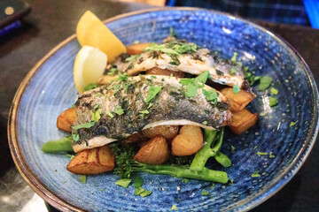 Grilled Fish on a Bed of Roasted Potatoes and Fresh Greens
