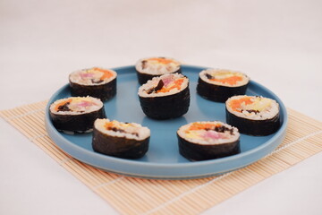 Sushi rolls on a plate on a white background. Japanese food