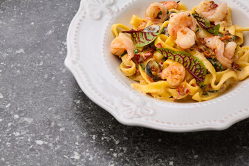 Shrimp fetticcine pasta. Italian pasta with shrimps and cream alfredo sauce, top view, copy space.