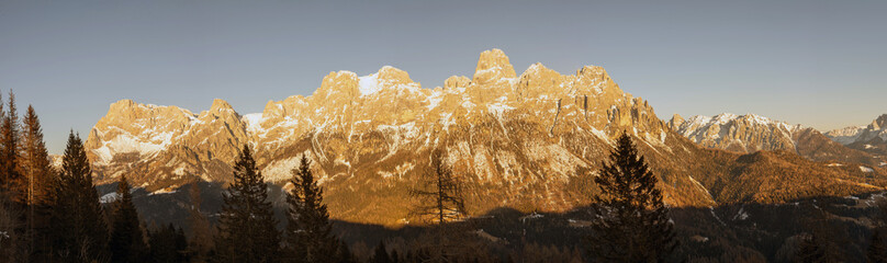 Dolomites, Italy - Panorama of Pale di San Martino in late afternoon light in winter - banner format