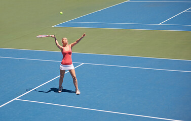 Woman, serving and game of tennis on court for sport, competition and start playing with ball and...