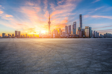 Asphalt road square and modern city buildings scenery at sunrise in Shanghai