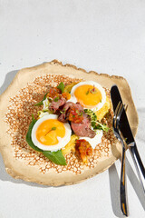 A beautifully arranged plate of potato pancakes with roast beef and a sunny side up egg, ready for breakfast