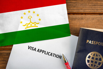 Visa application form, passport and flag of Tajikistan
