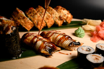 Focus on two nigiri covered with brown sauce from a bottle