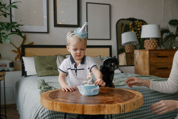 Boy blowing out a candle on a birthday cake