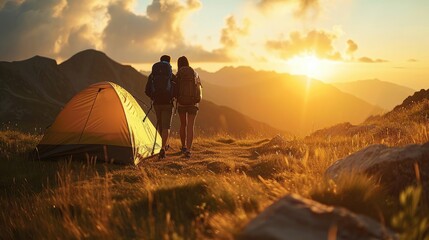Fototapeta na wymiar Rear view of Image of a tourist couple carrying a backpack on their backs, Sunset view of a camping tent high in the mountains. Golden sunlight casting 