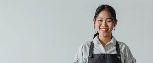 Foto op Canvas young smiling welcome asian female woman business owner wear apron hand holding tablet ready for your order on white color background, restaurant, pretty, uniform © Polpimol