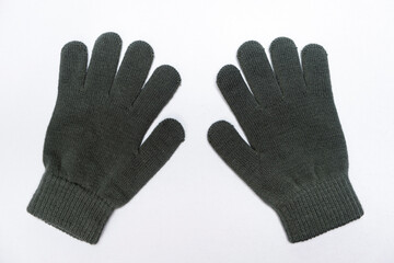 Warm winter childrens gloves mittens made of acrylic and wool on white background isolate