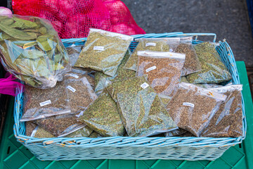 Medicinal, aromatic and cooking herbs for sale in transparent plastic bags in a traditional market....