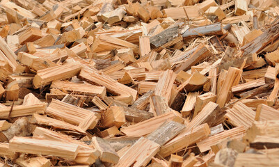 Pile of chopped and split firewood, background, texture, tree trunks ready for fire and heat in winter
