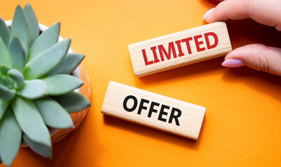 Limited Offer symbol. Concept word Limited Offer on wooden blocks. Businessman hand. Beautiful...