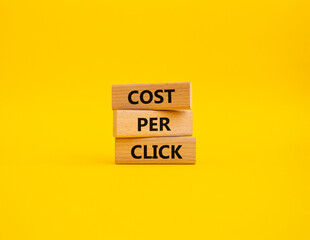 Cost Per Click symbol. Concept word Cost Per Click on wooden cubes. Beautiful yellow background. Business and Cost Per Click concept. Copy space.