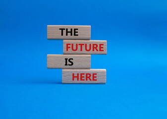 The future is here symbol. Concept words The future is here on wooden blocks. Beautiful blue background. Business and The future is here concept. Copy space.