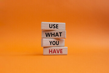 Use what you Have symbol. Concept words Use what you Have on wooden blocks. Beautiful orange background. Business and Use what you Have concept. Copy space.