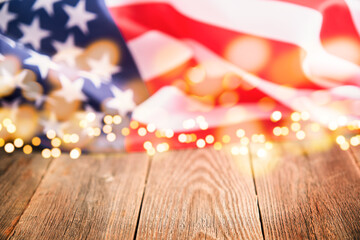 4th of July background. Empty wooden plank table with American USA flag and burning sparkler fireworks and golden lights bokeh. Happy Labor , Independence or Presidents Day. American flag colors.
