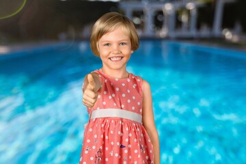 Happy cute child at swimming pool.