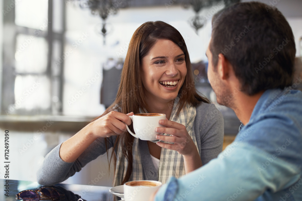 Wall mural Love, smile and couple drinking coffee in cafe, care and bonding together on valentines day date. Happy man, woman in restaurant and tea for connection, conversation and healthy relationship in shop