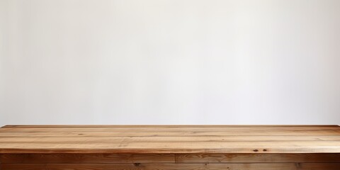 Wooden table with white wall as backdrop