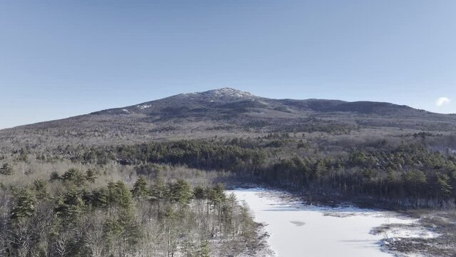 Mount Monadnock on winter day in southern New Hampshire. Wide establishing drone shot HDR ProRes video.