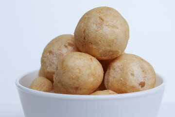 Fish crackers in ball shape, on a white bowl. isolated on white background