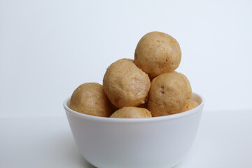 Fish crackers in ball shape, on a white bowl. isolated on white background
