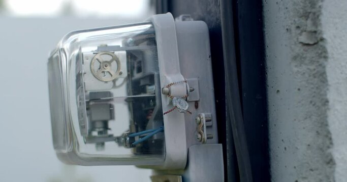 Electrometer measuring electricity consumption.Close-up side of a domestic electric meter and dial turning.