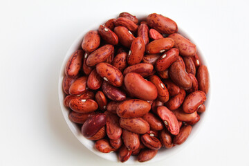 Red kidney bean, in a bowl, isolated on white background, flat lay or top view
