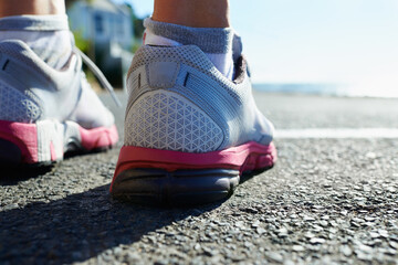 Feet, rear view and runner on street for fitness, health or cardio training in preparation or...
