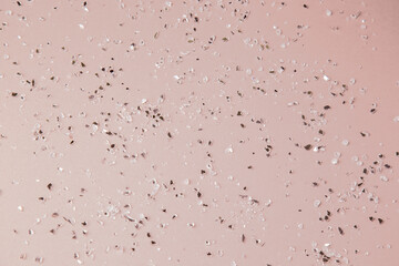 brocken glass drops on beige background