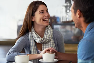 Poster Relax couple, coffee shop and woman laughing over funny joke, conversation or romantic date in diner, cafe or restaurant. Relationship humour, comedy and cafeteria people bonding over espresso drinks © Miko/peopleimages.com