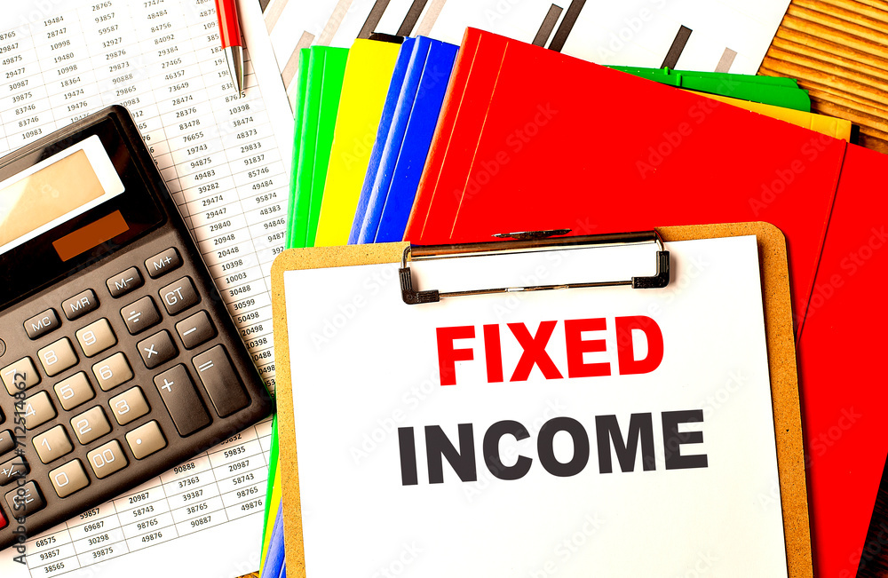 Aufkleber fixed income text written on paper clipboard with chart and calculator