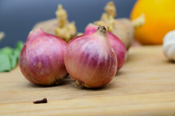 fresh garlic and onion on wooden table, garlic, tomatoes, artichoke. Fresh produce. Harvest. Agriculture. Nutrition