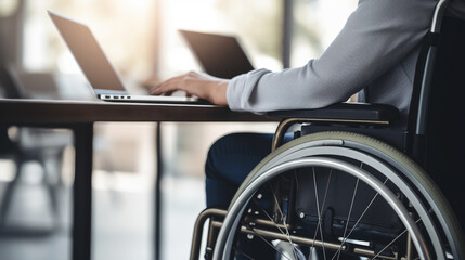 Fototapeta premium Man in wheelchair working in business on his laptop