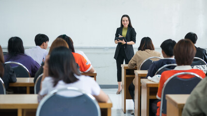 Education, teaching, learning concept. Asian university lecturer teaching lesson to students in...